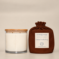 Sandalwood, Orange & Vanilla 1.5kg Soy Candle in a glass container with timber lid and chocolate brown fabric gift bag