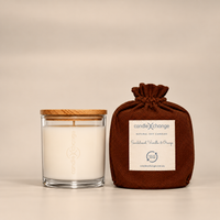 Sandalwood, Orange & Vanilla 300g Soy Candle in a glass container with timber lid and chocolate brown fabric gift bag