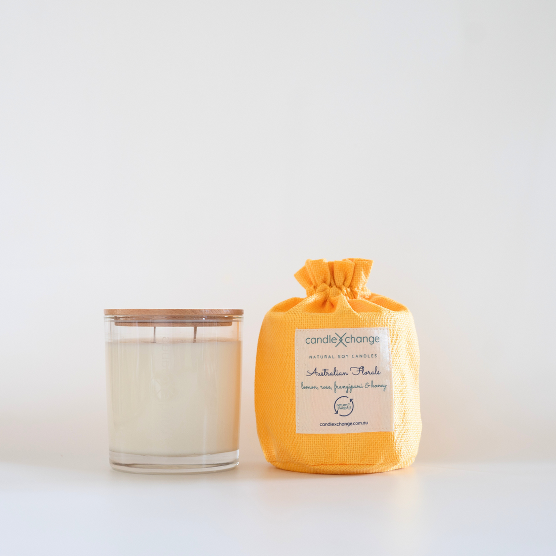 Candle and its packaging on a white background