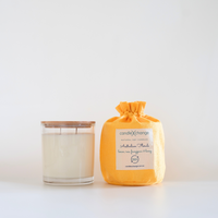 Candle and its packaging on a white background