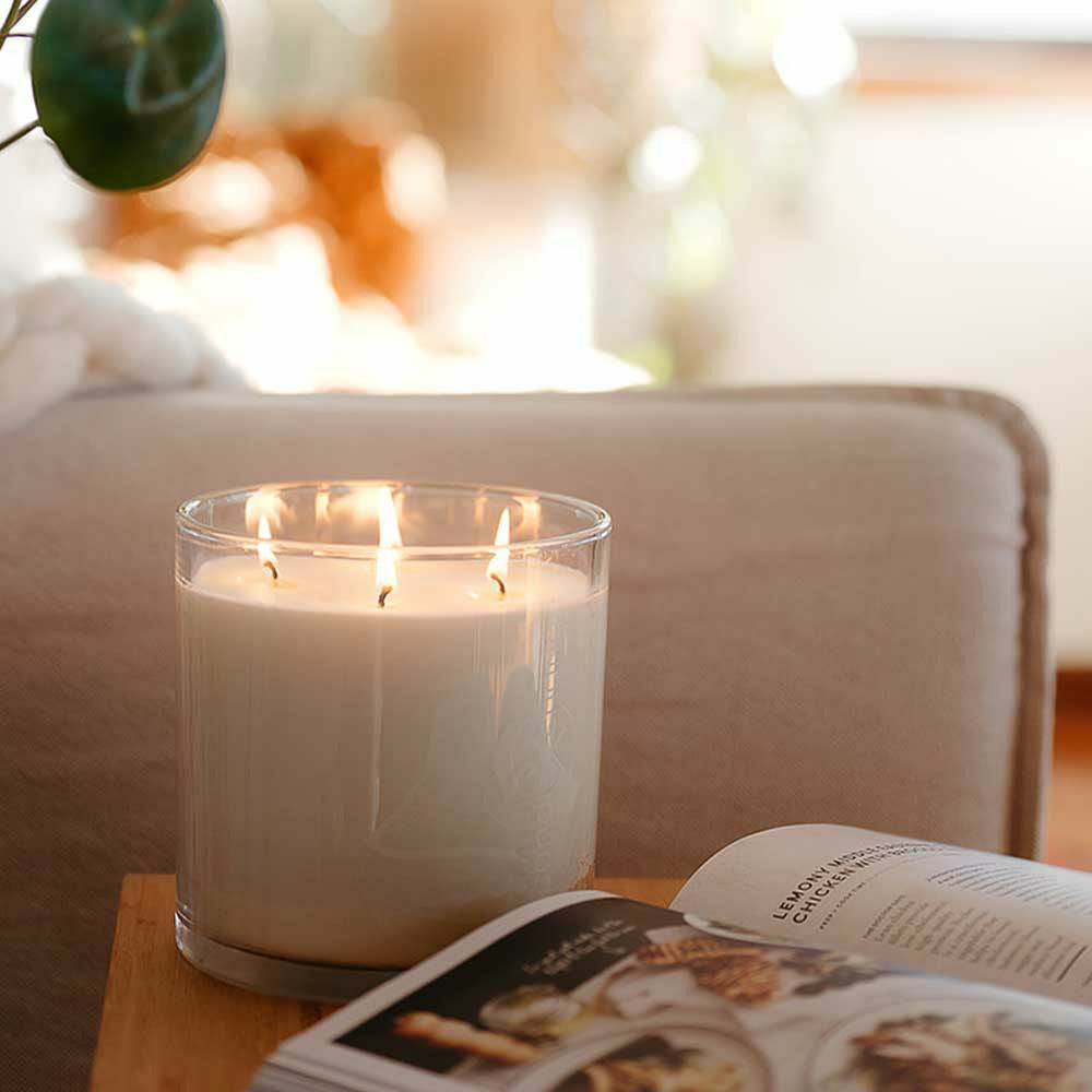 CandleXchange 1.5L candle sitting on side table next to lounge
